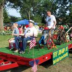 Frank Held's grandson Frank Held along with great grandson Kaleb Held and great great grandson Keegan Held on the GroMor parade float. 